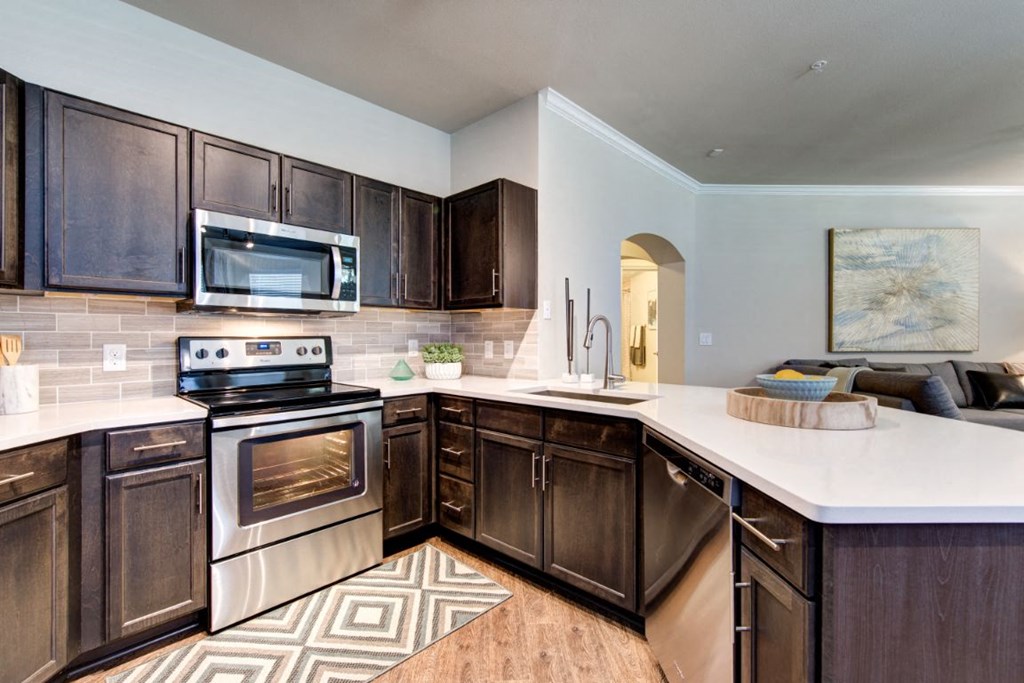 a kitchen with stainless steel appliances and wooden cabinets