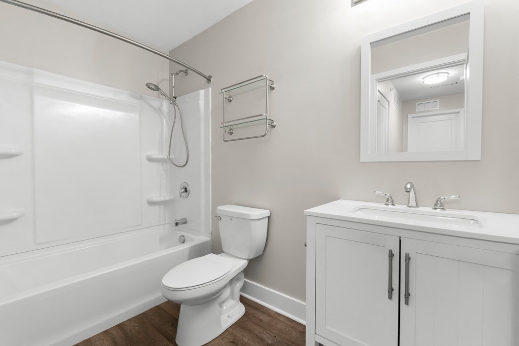 a white bathroom with a toilet sink and shower