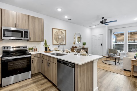 A modern kitchen with wooden cabinets and stainless steel appliances. Brand new with modern finishes and appliances.