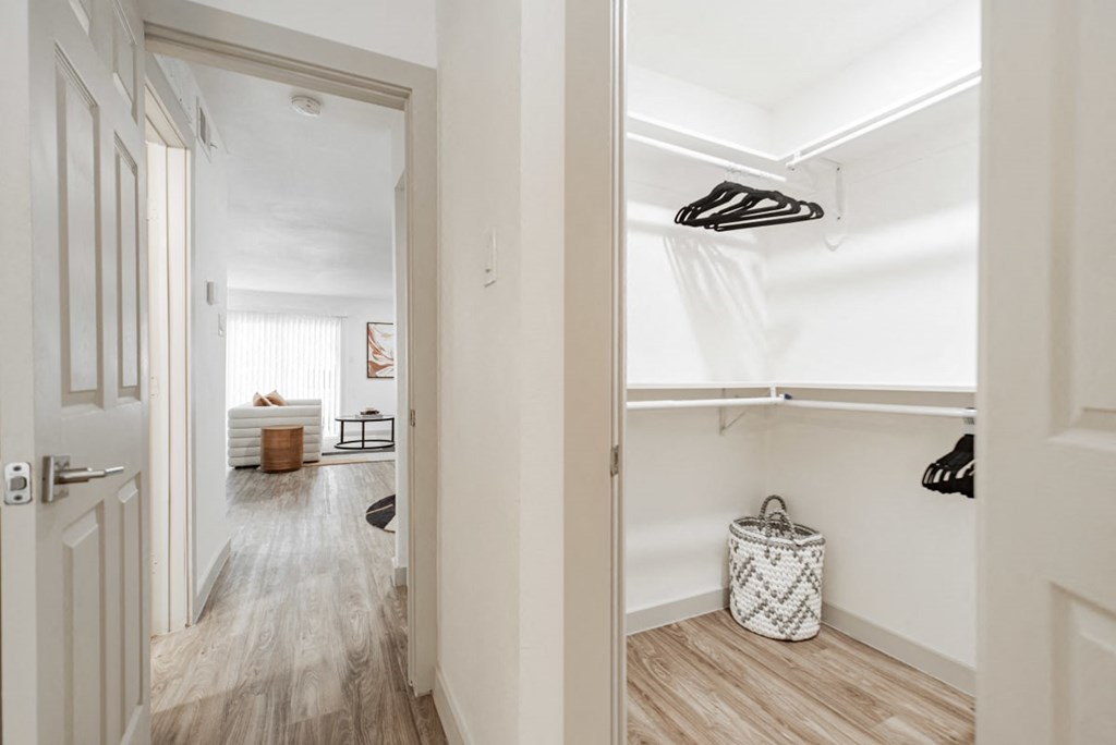 A hallway with a white door and a white bag on the floor.