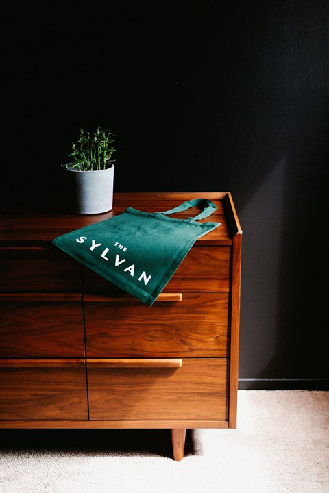a wooden dresser with a green towel on top of it