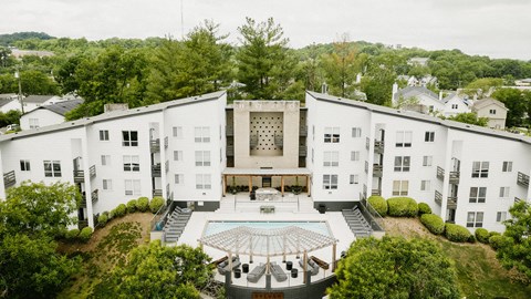 an aerial view of a large white building with a courtyard and a pool