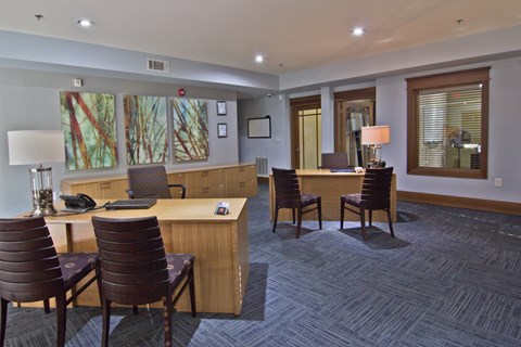 A conference room with a long table and chairs.
