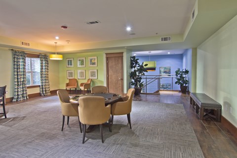 A dining room with a table and chairs.