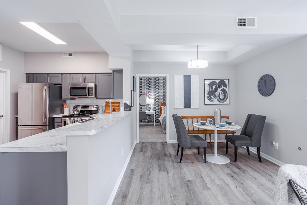 A modern kitchen with a dining area.