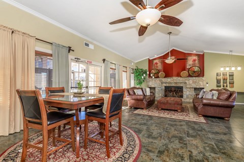 A dining room with a table set for four.