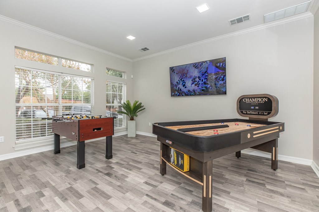 a games room with a foosball table and a ping pong table