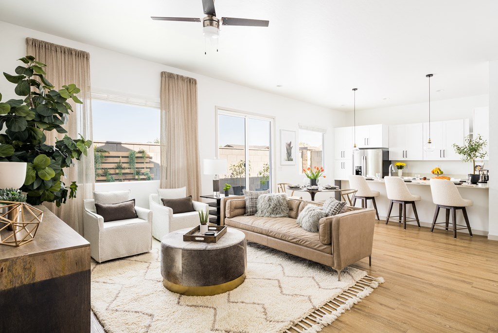 a living room with white walls and hardwood floors