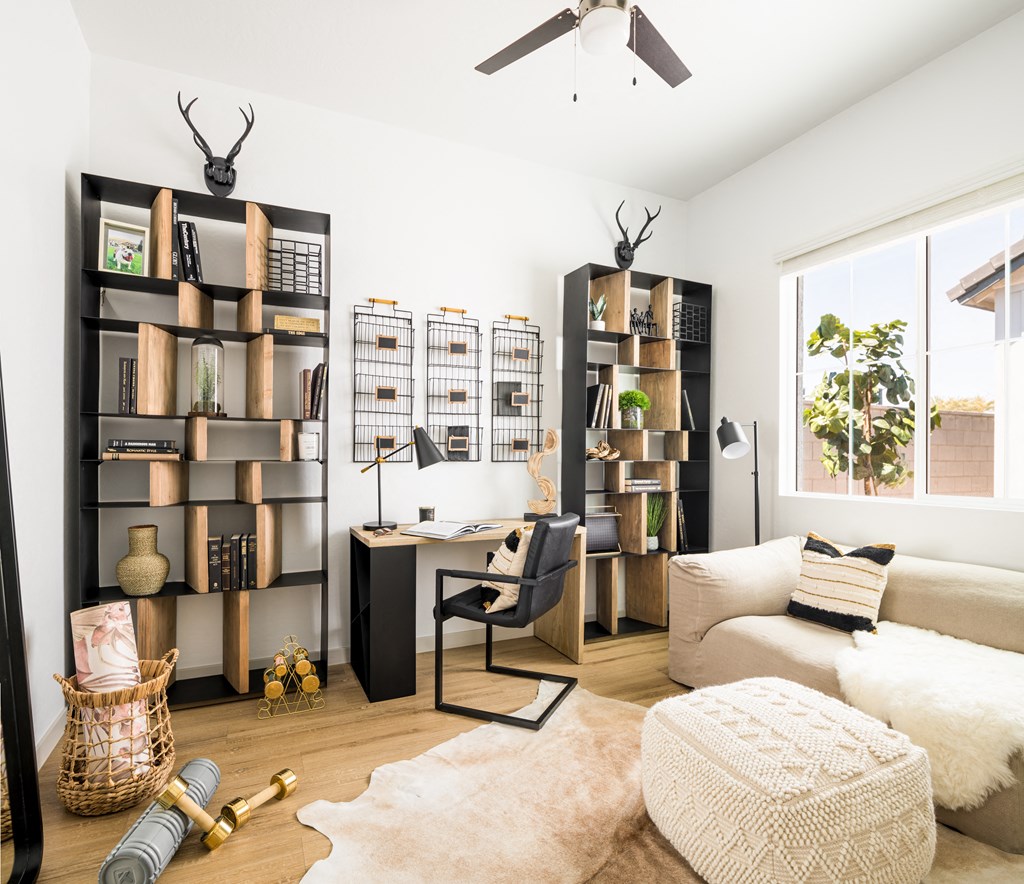 a home office with a desk and bookshelves