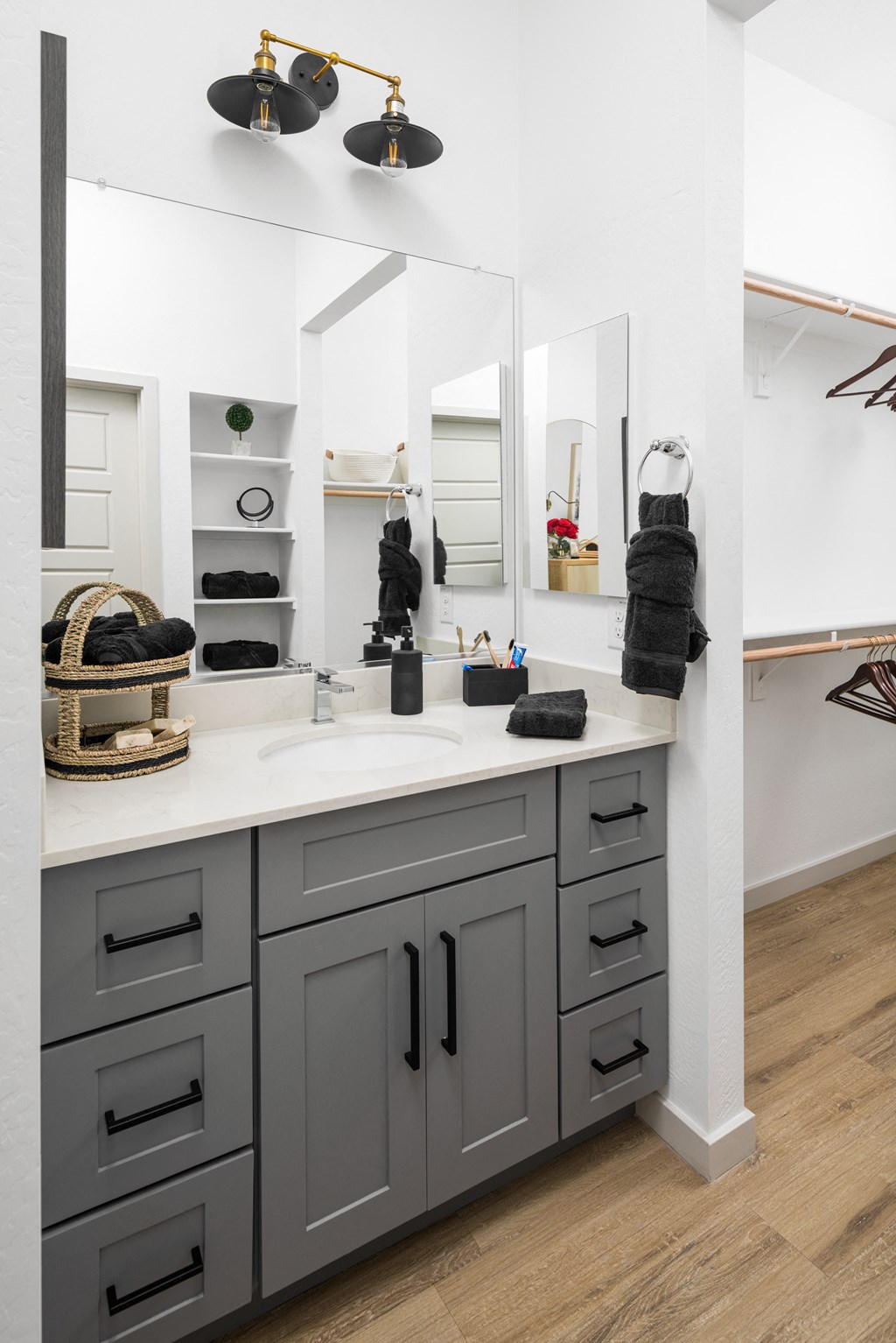 a bathroom with gray cabinets and a white countertop