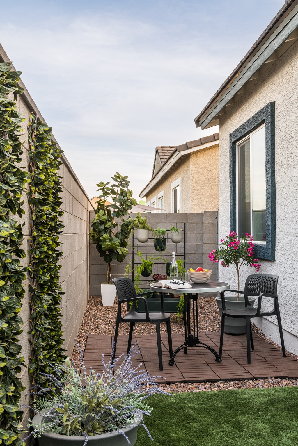 a small patio with a table and chairs