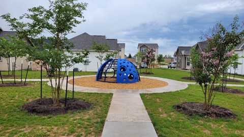 a blue sculpture in the middle of a walkway