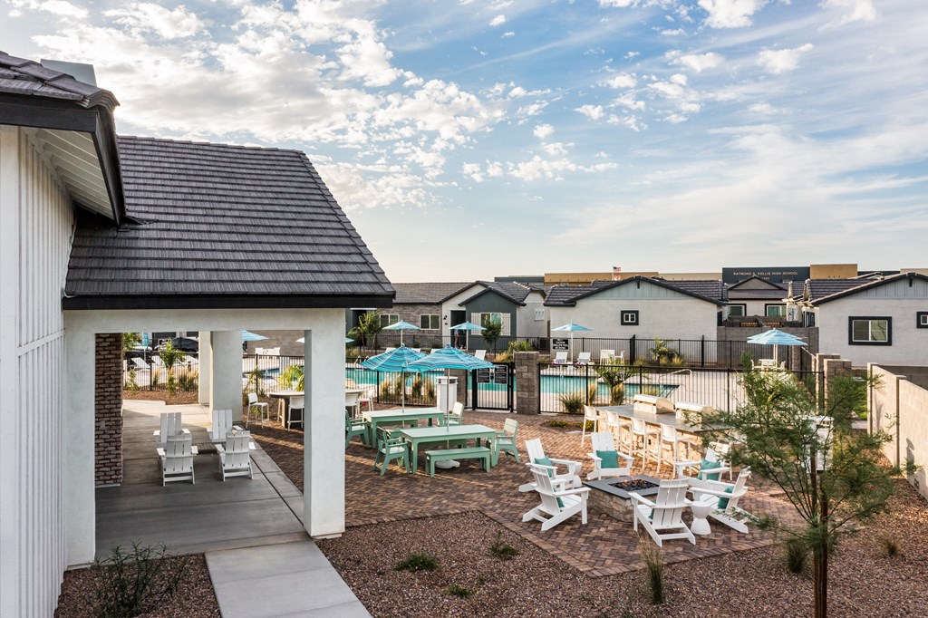 an outdoor patio with tables and chairs at the enclave at woodbury apartments