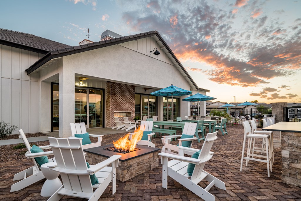 an outdoor patio with chairs and a fire pit