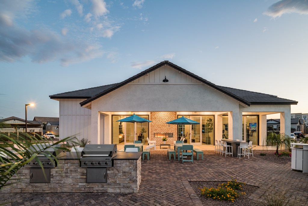 the exterior of a home with patio furniture and a grill