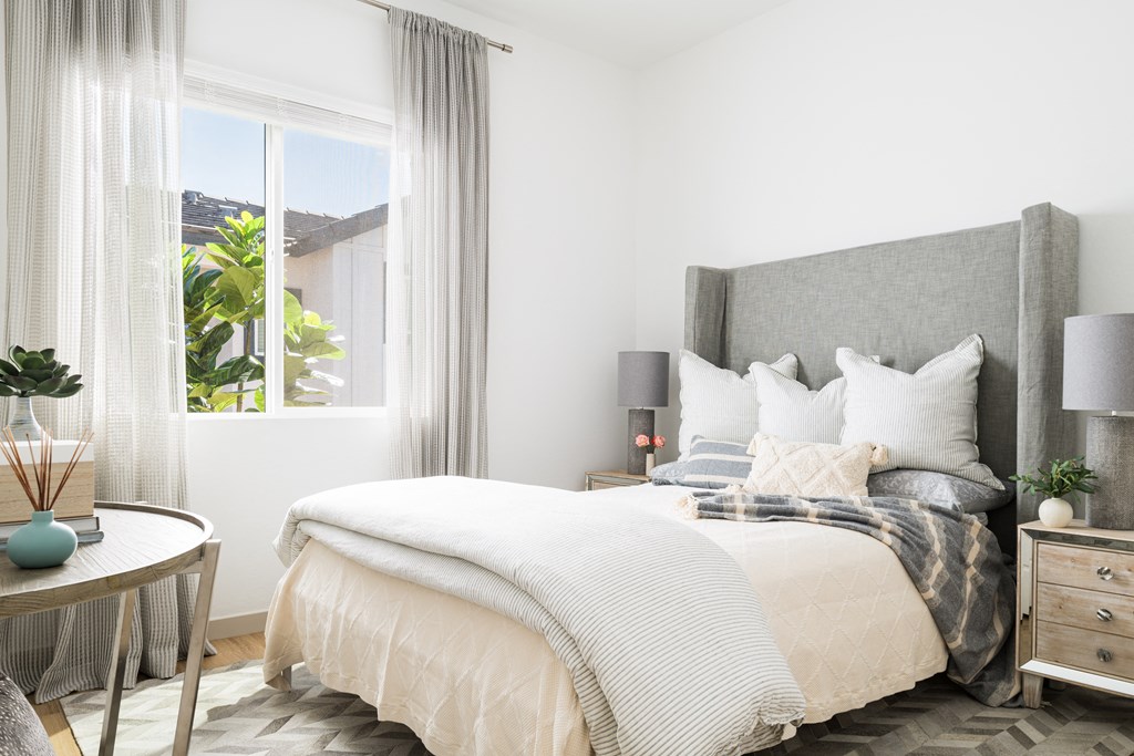 a bedroom with a bed and a window