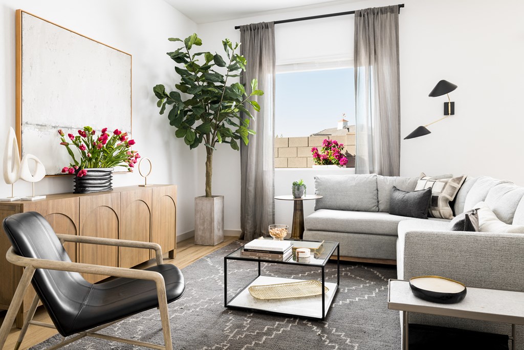 a living room with a couch and a chair and a table