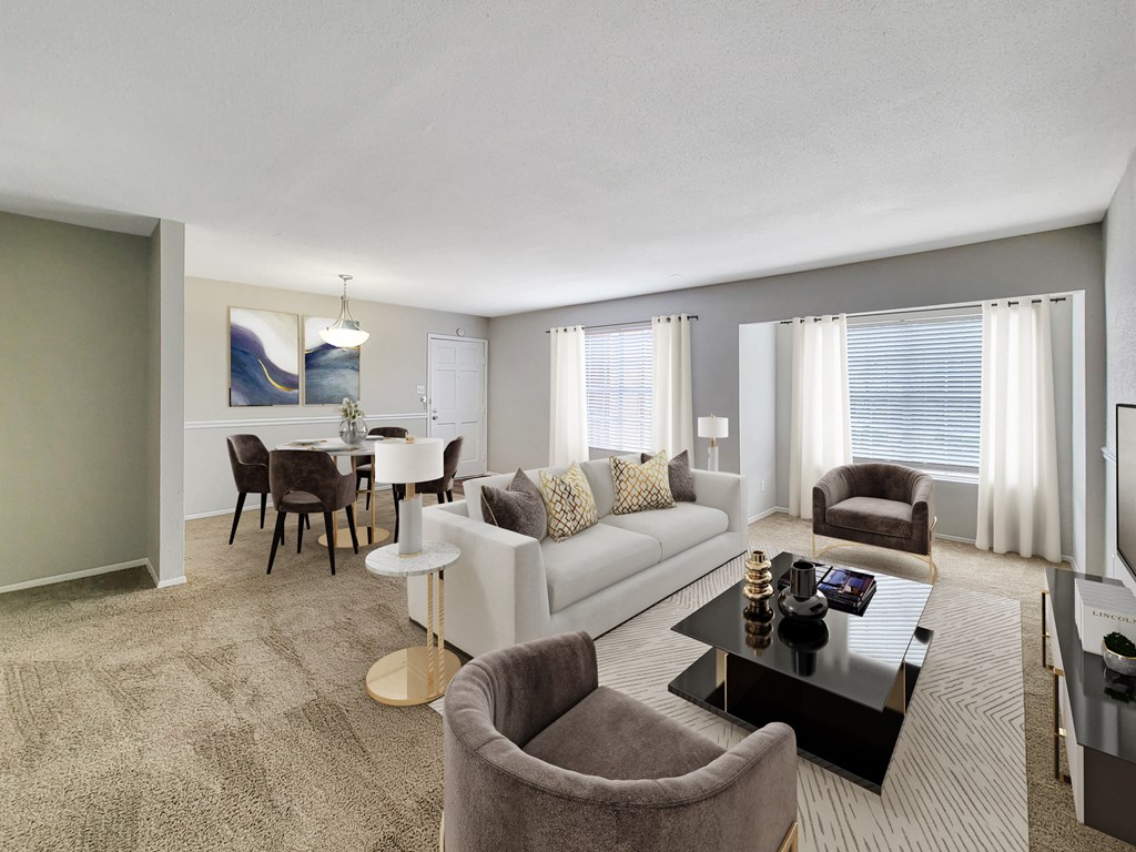 a living room with a couch a table and a chair