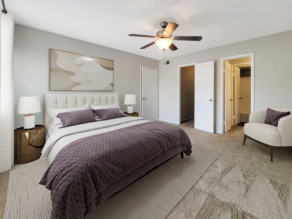 a bedroom with a bed and a ceiling fan