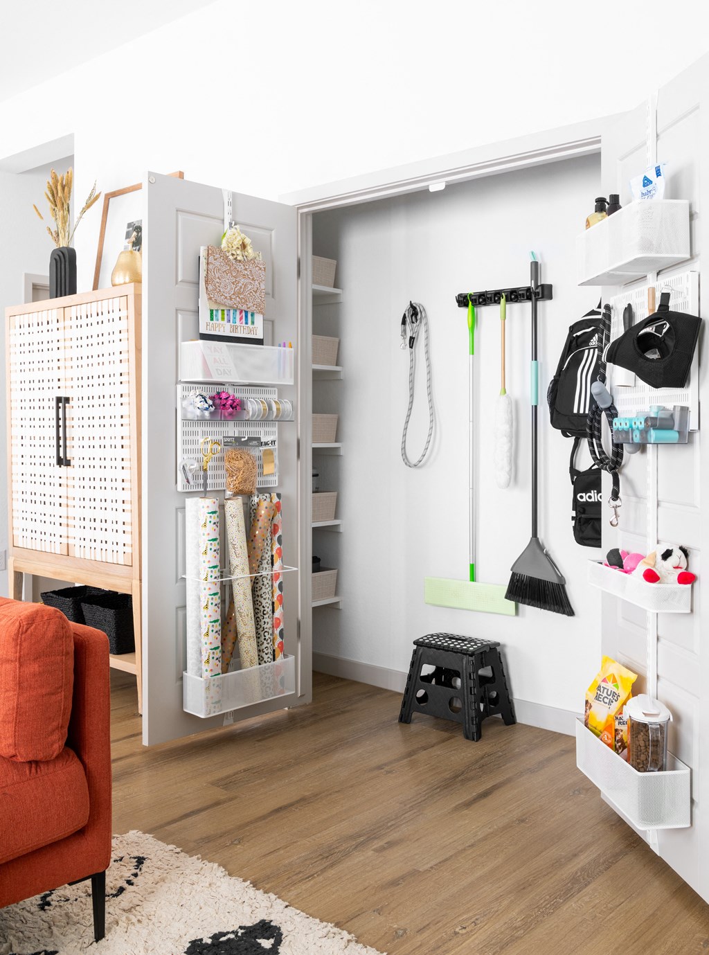 a small room with a closet and a chair and an orange couch