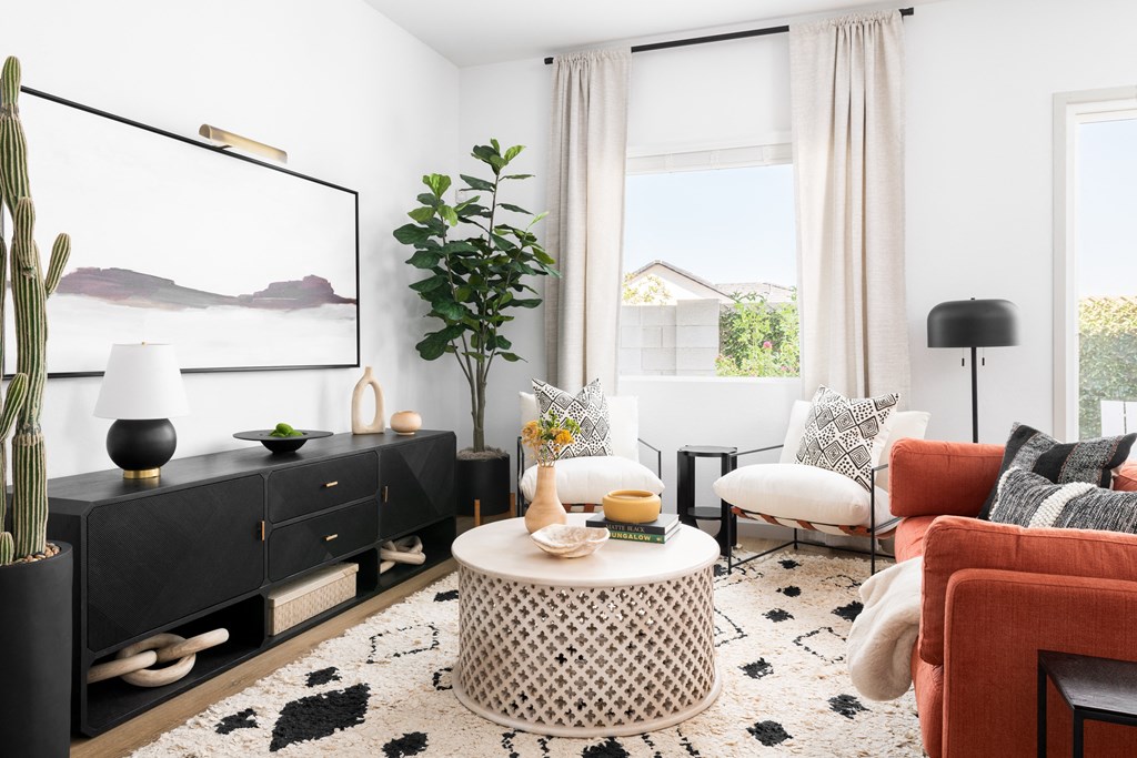 a living room with white walls and black furniture and a black entertainment center