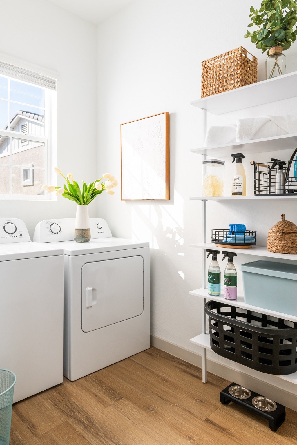 a small laundry room with a washing machine and a window