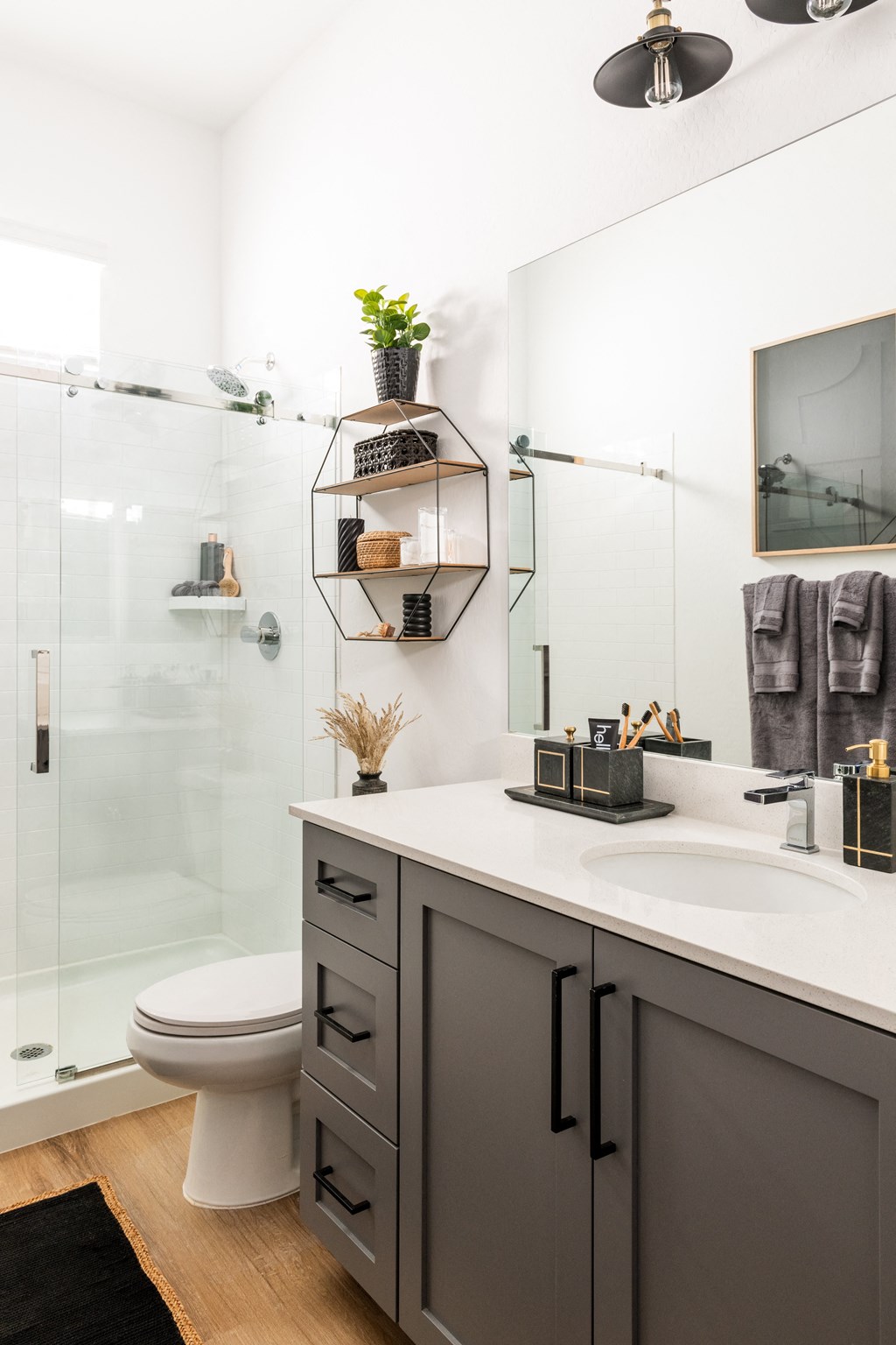a white bathroom with a shower and a sink and a toilet