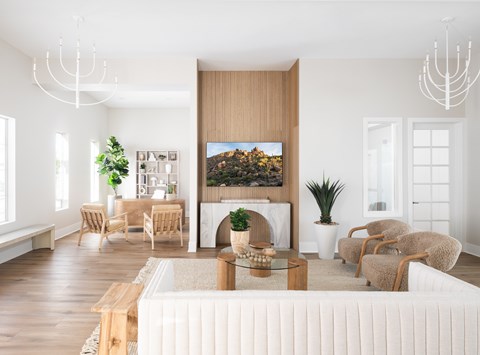 A modern living room with a large painting on the wall and a white sofa.