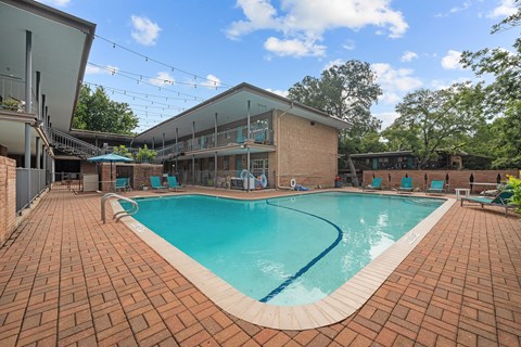a swimming pool with a building in the background