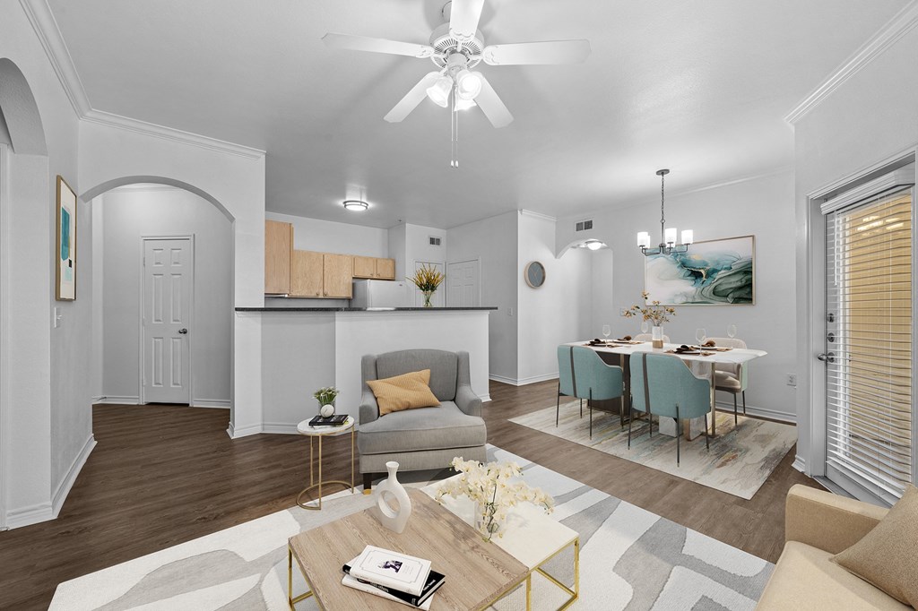 a living room and dining room with a table and a ceiling fan