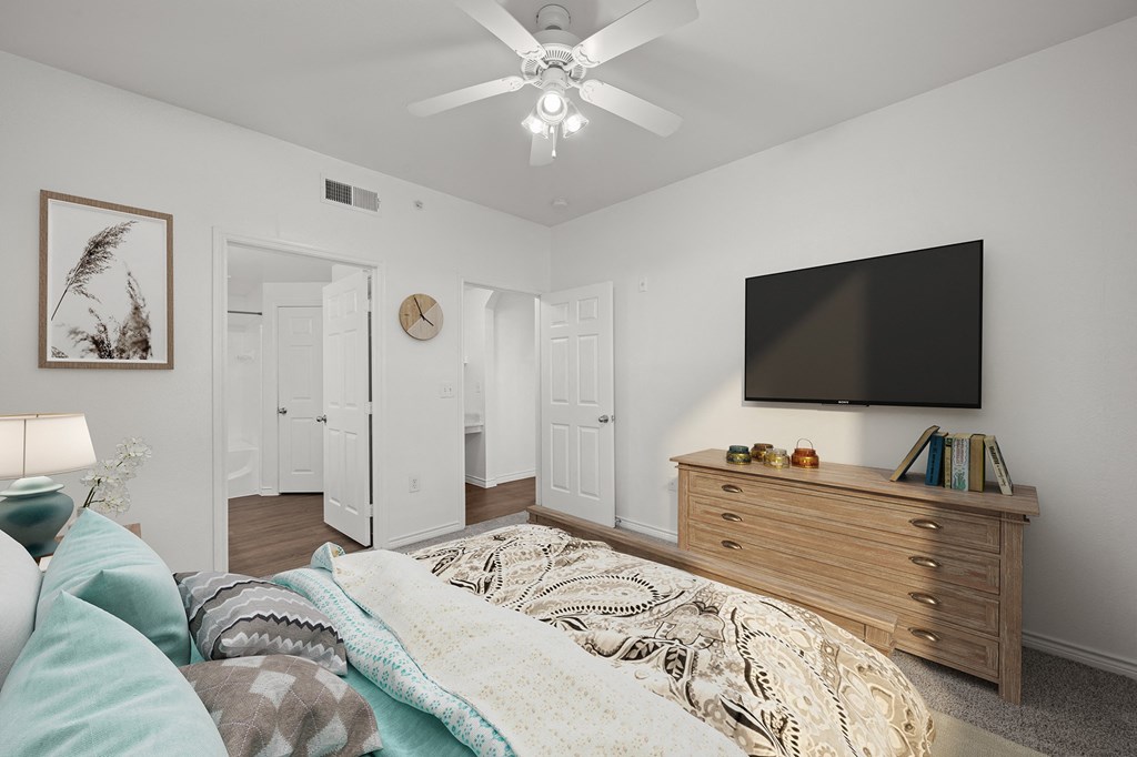 a bedroom with a bed and a ceiling fan