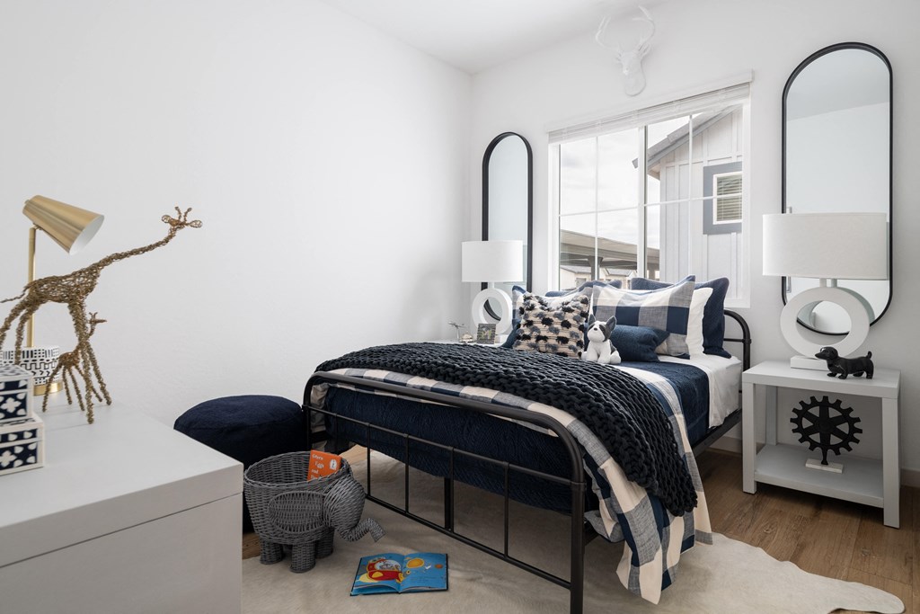 a bedroom with a bed and a dresser and a mirror