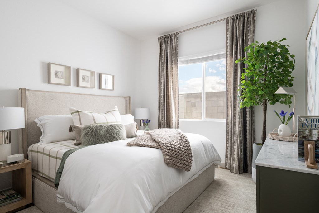 a bedroom with a large bed and a window