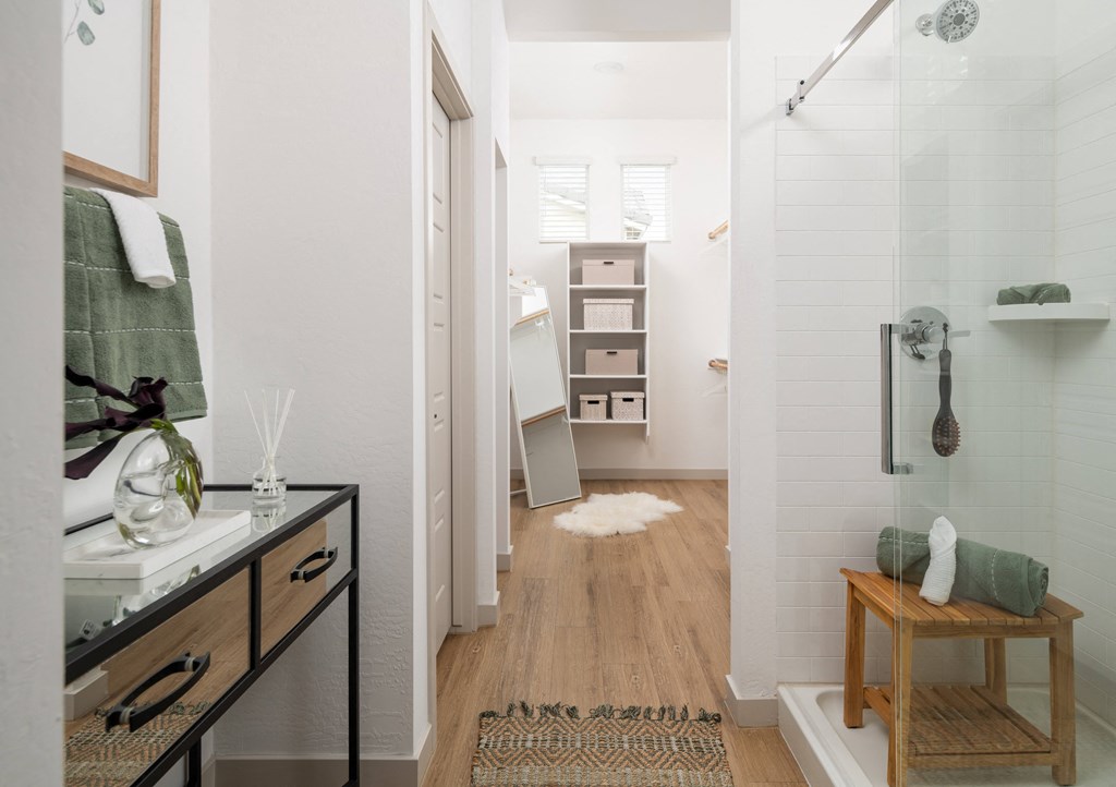 a bathroom with a shower and a sink and a mirror