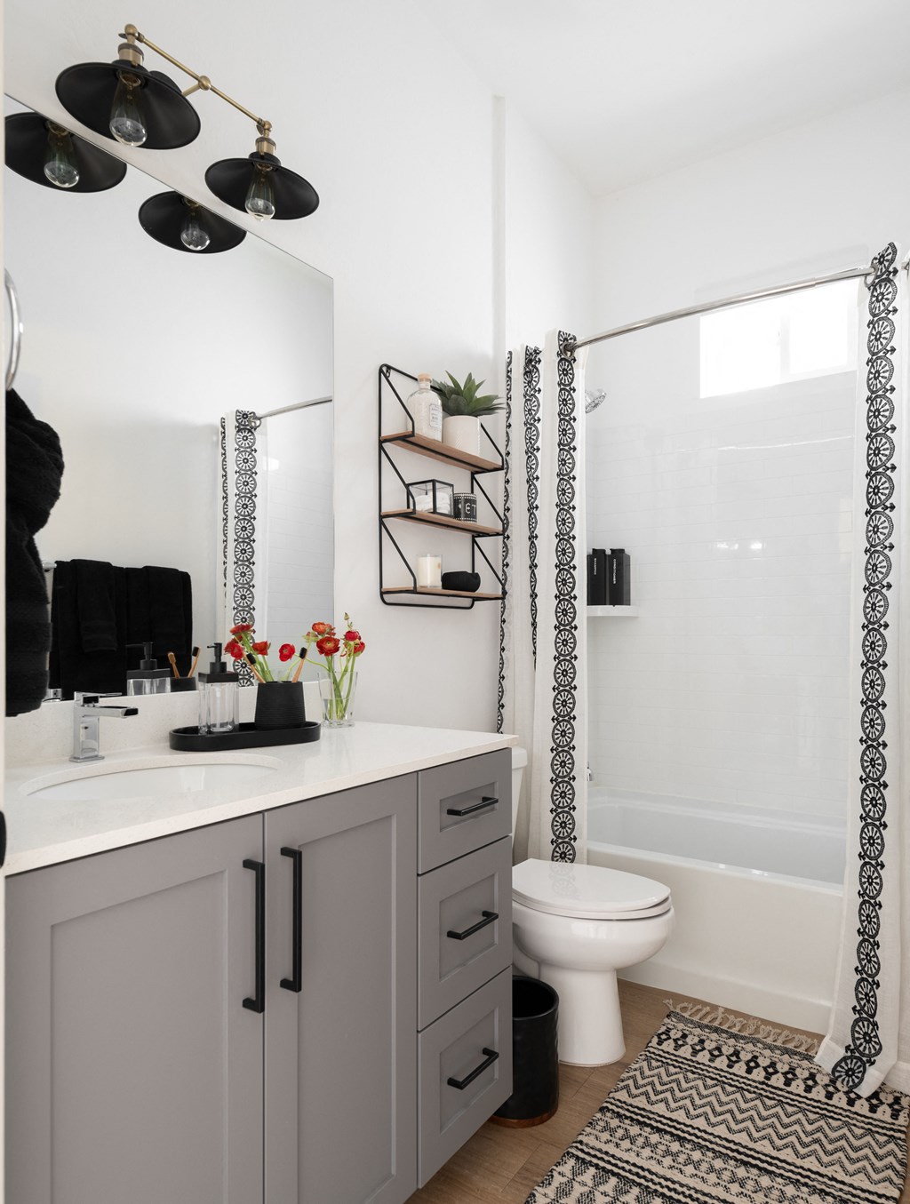 a bathroom with a white toilet and a sink and a shower