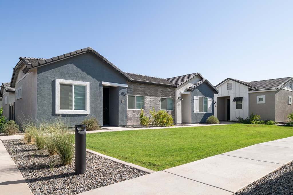 A modern house with a grey exterior and a white window.