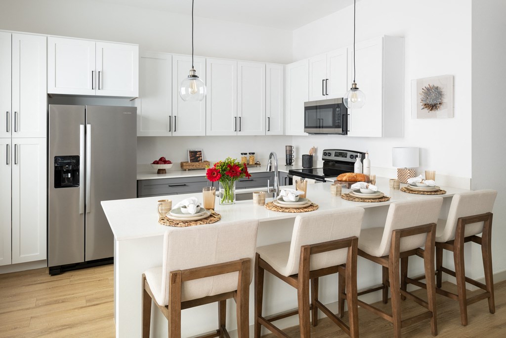 a kitchen with a large island with a white counter top