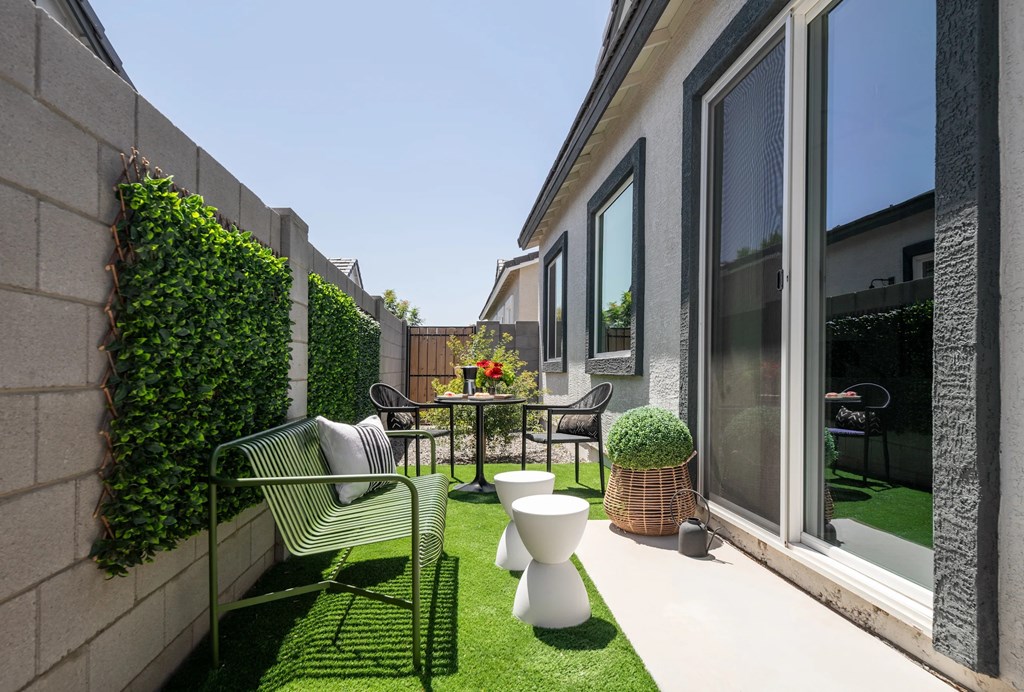 A small patio with a table and chairs.