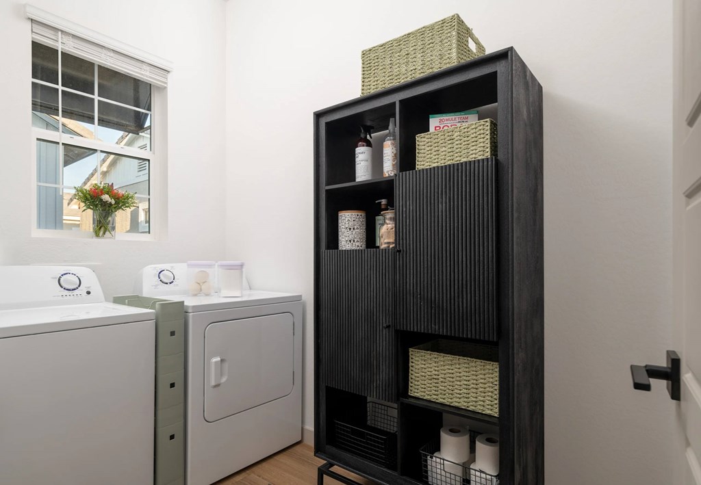 A black shelf with various items on it in a room.