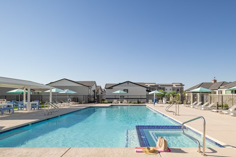A swimming pool with a hat and a towel on the side.