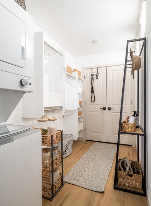 A white oven sits next to a white fridge in a small kitchen.