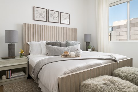 A bedroom with a large bed and a window.