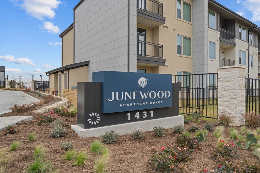 A sign for a residential area named Junewood with the number 1431 on it.