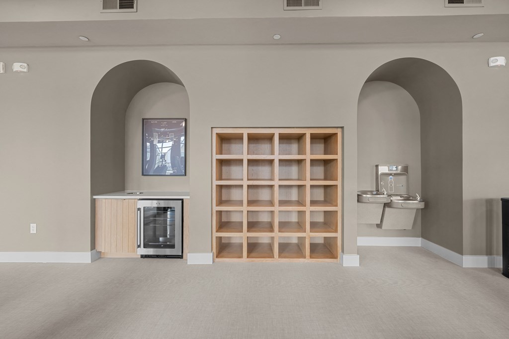 A room with a wine rack and a fridge.
