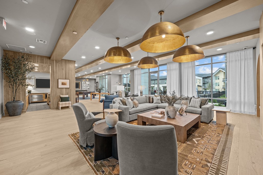 A modern living room with a grey sofa set and a wooden coffee table.