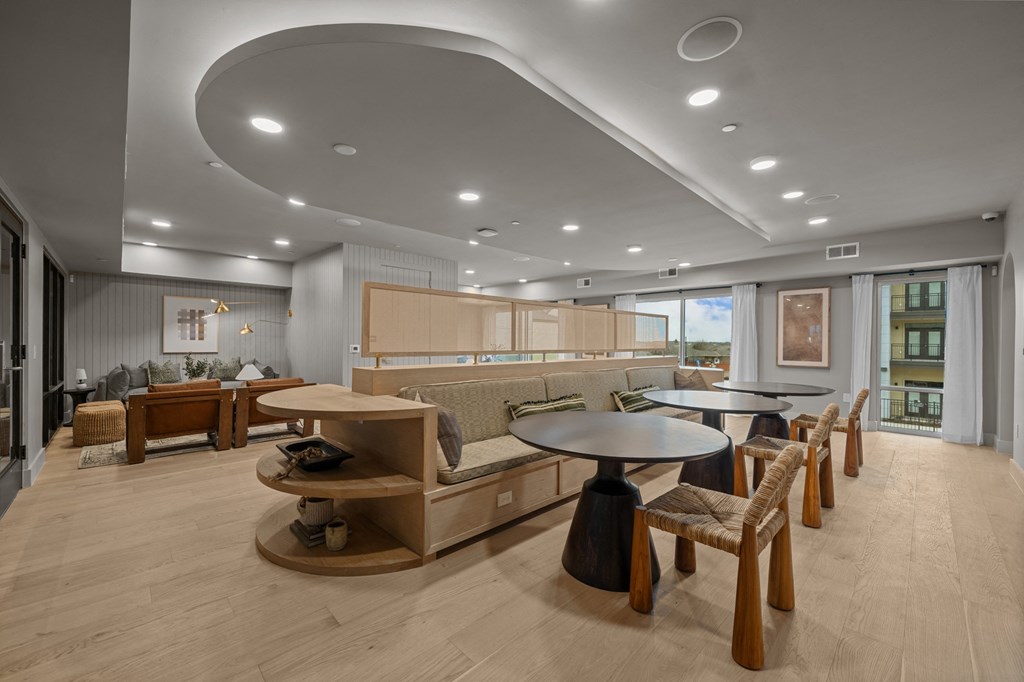 A modern living room with a curved ceiling and wooden furniture.