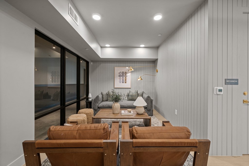 A modern living room with a glass door leading to a balcony.