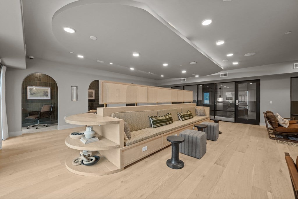 A modern living room with a curved sofa and a coffee table.