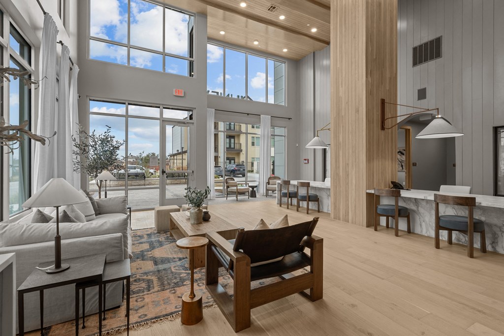 A modern living room with a large window and a wooden floor.
