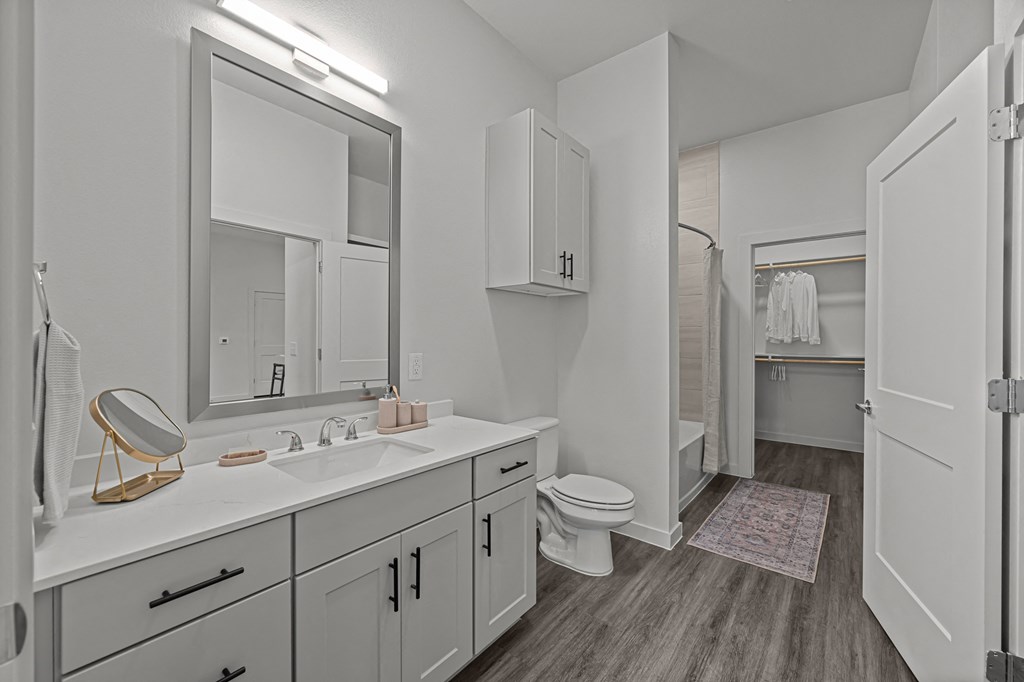 A bathroom with a white sink and toilet.